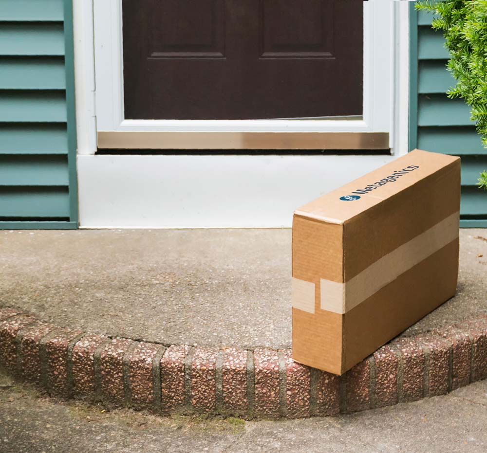 Box of Metagenics supplements sitting on a doorstep after delivery